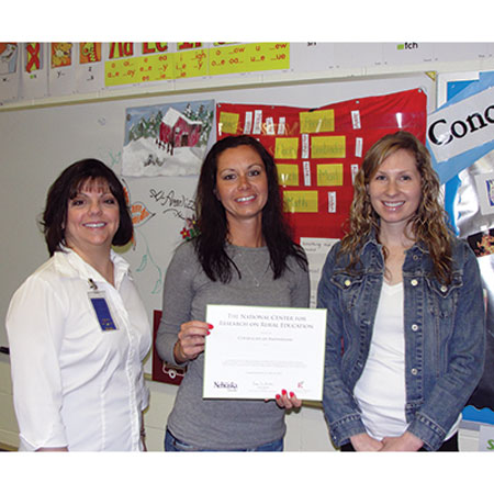 A Shell Creek teacher accepts recognition for her participation in an R2Ed project