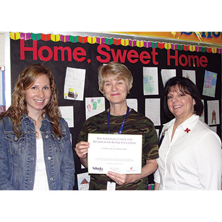 A Shell Creek teacher accepts recognition for her participation in an R2Ed project